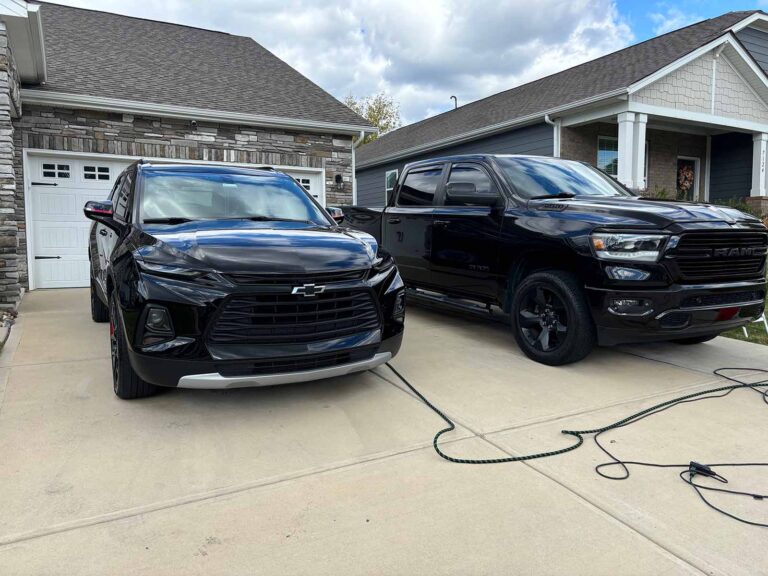 Two trucks in the front of a house, freshly detailed by us in Rock Hill.