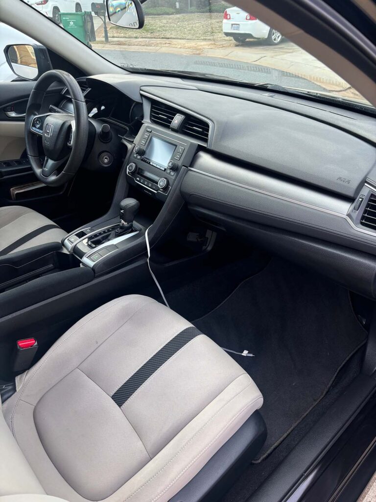 An interior detail including controls and front dash.