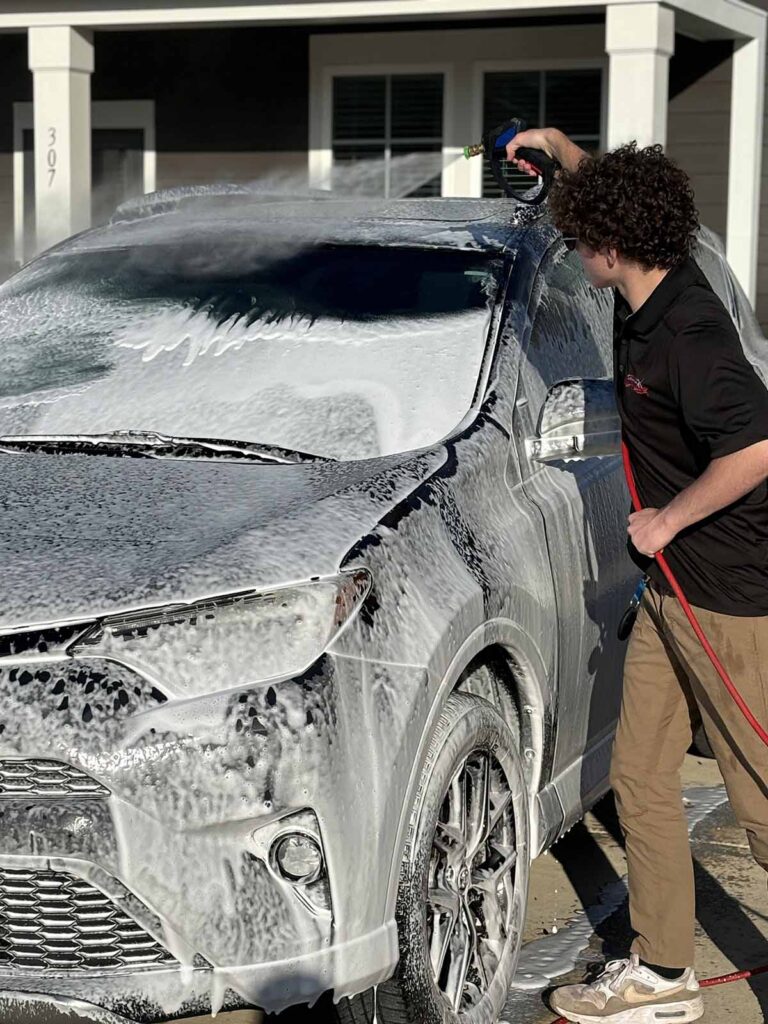 One of our technicians, detailing a car in a Matthews, NC neighborhood.