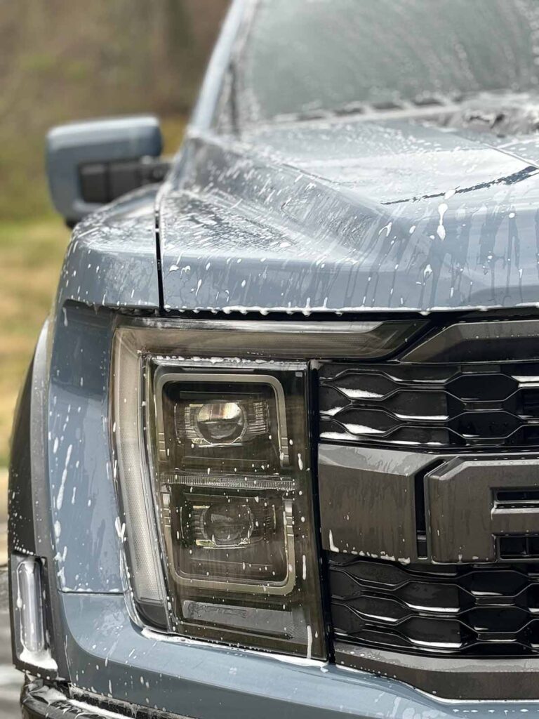 A Ford truck having its headlights restored in the Southpark area.