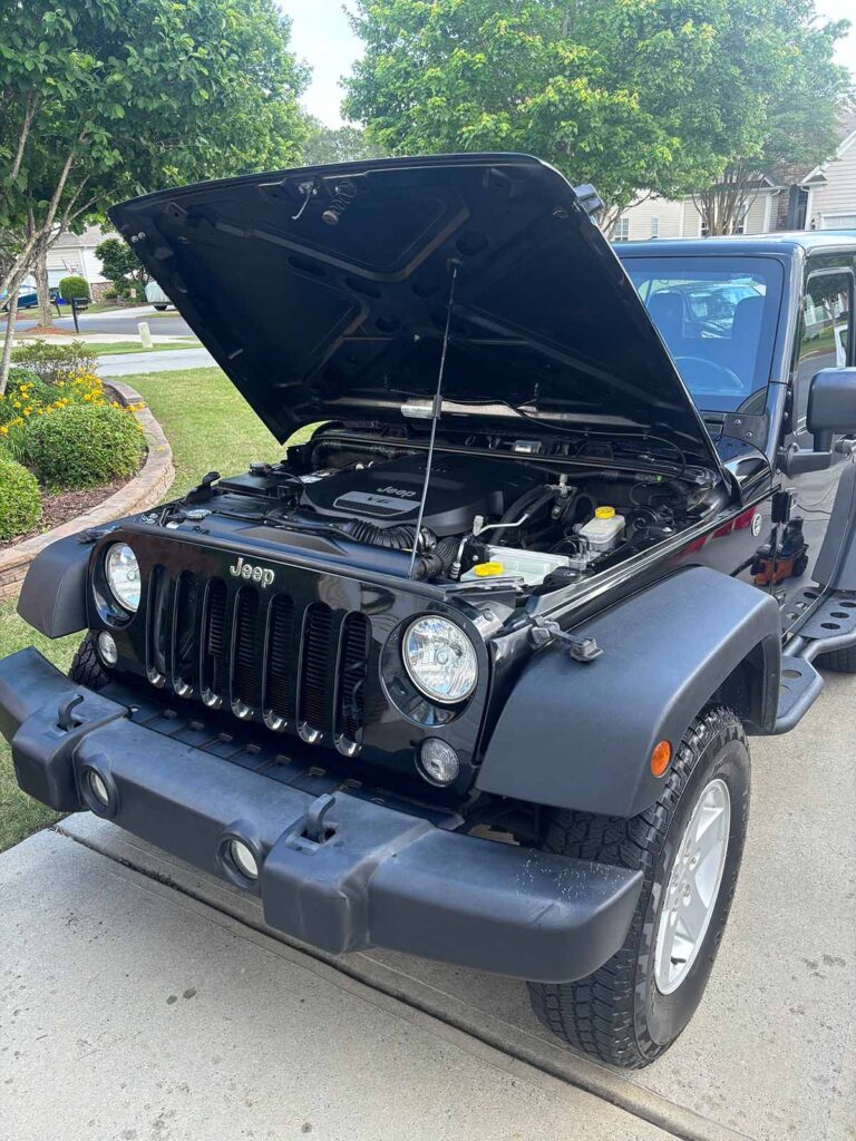 Angle 1 of an engine bay detailing job on a Jeep in the Fort Mill area.