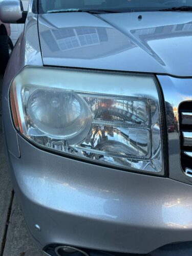 Angle 1 of a Honda before headlight restoration.