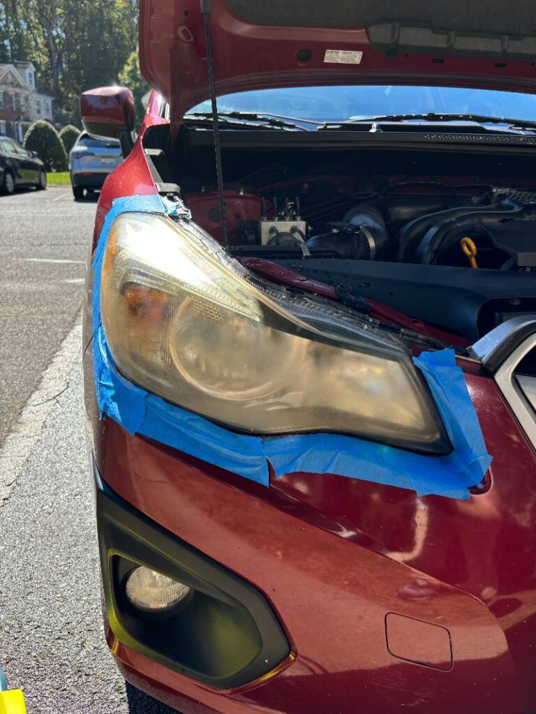 Angle 1 of a Subaru before headlight restoration.